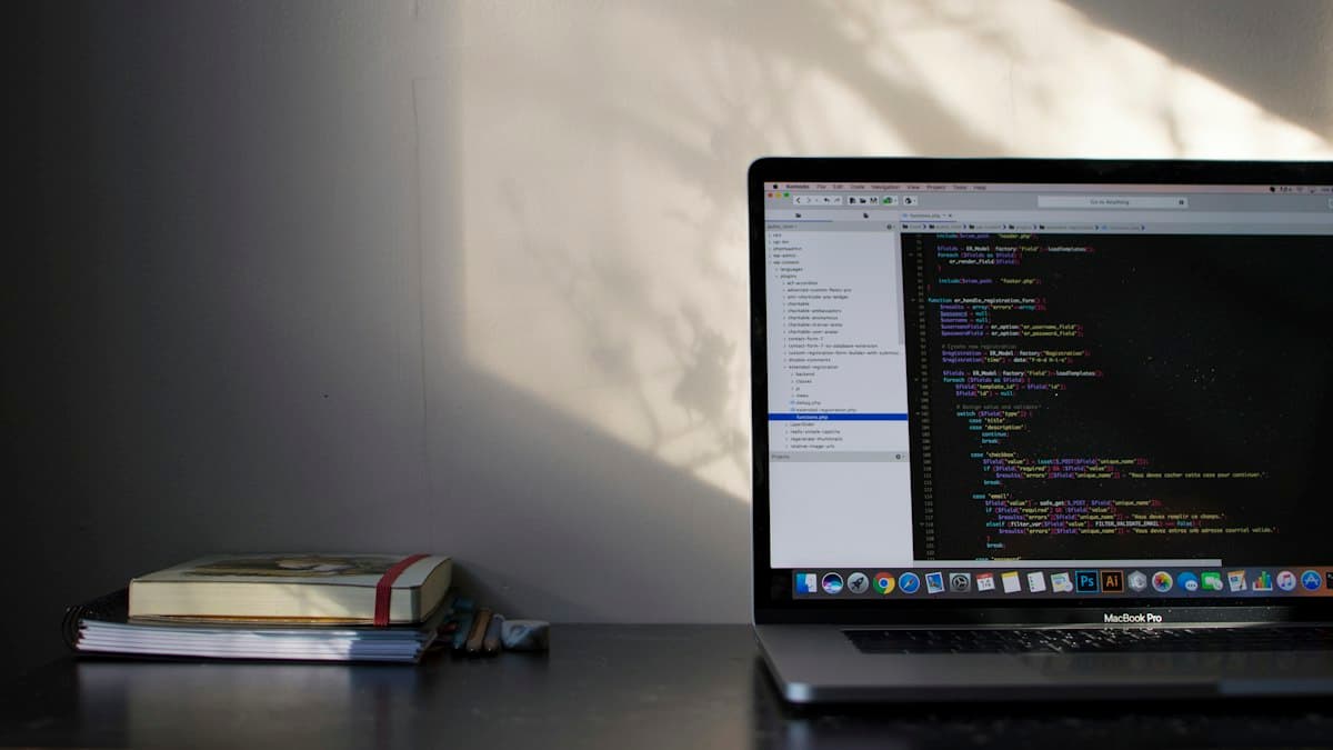 A laptop with code in a sunlit room